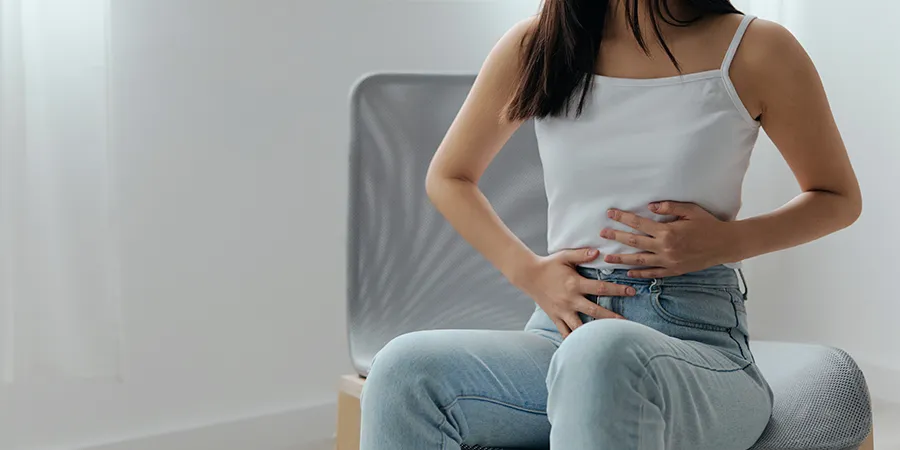 Person experiencing IBS symptoms