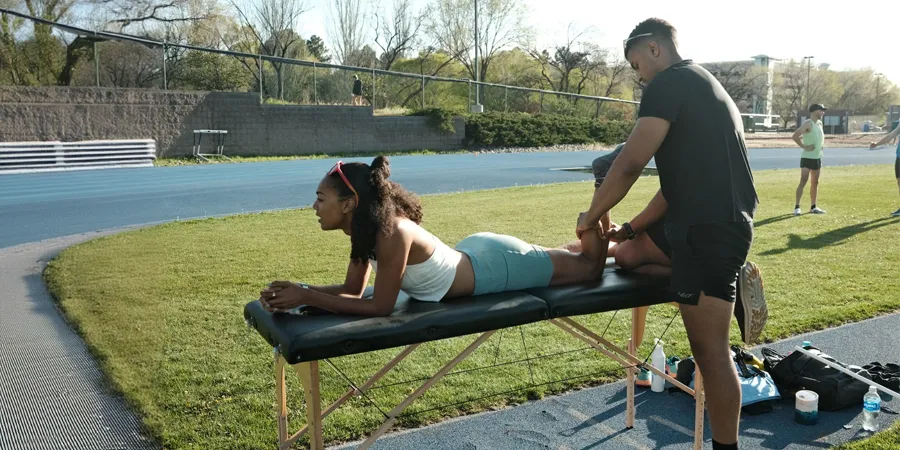 Jumaane Bant providing sports massage and sports therapy to help Adelle Tracey's recovery and performance